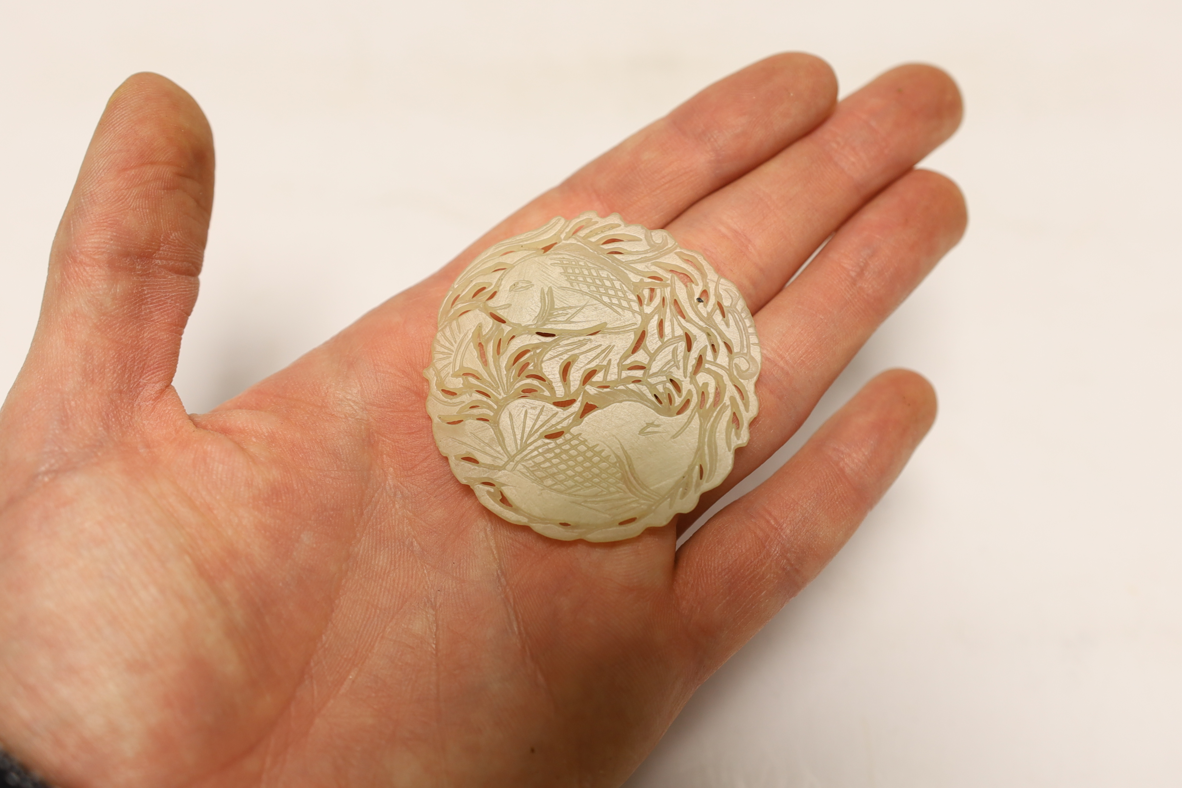 Two Chinese lion dog seals, a carved jade disc, a hard stone disc with partial wax seal and carved figure
